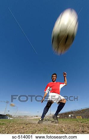 Stock Image - Boy kicking Soccer ball. Fotosearch