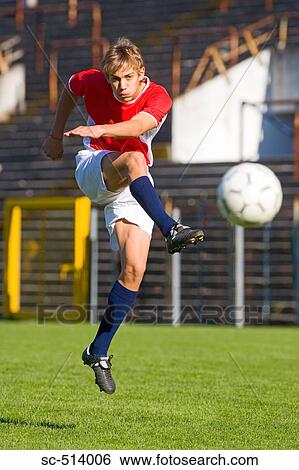 Stock Photograph - Boy kicking Soccer ball. Fotosearch