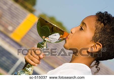 Boy kissing a trophy View Large Photo Image Stock Photo - Boy kissing a trophy. Fotosearch