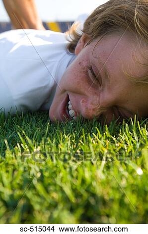 Picture - Boy laughing in grass. Fotosearch