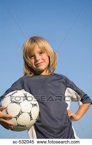 Boy posing with football under arm View Large Photo Image Stock Photography - Boy posing with football under arm . Fotosearch