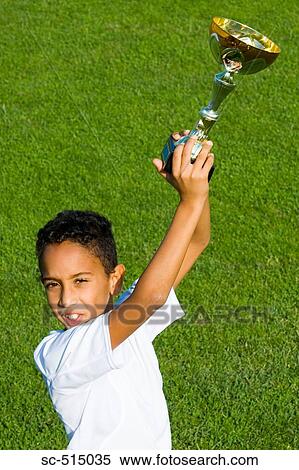 Stock Photography - Boy raising the trophy. Fotosearch
