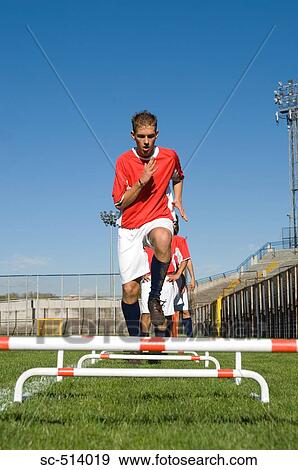 Boy running over training bars View Large Photo Image Stock Photo - Boy running over training bars. Fotosearch