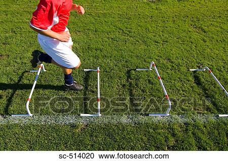 Stock Image - Boy running through an obstacle. Fotosearch