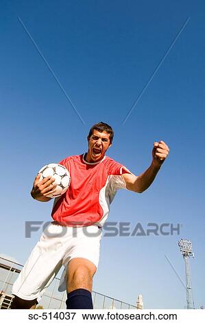 Stock Photo - Boy shouting and punching the air. Fotosearch