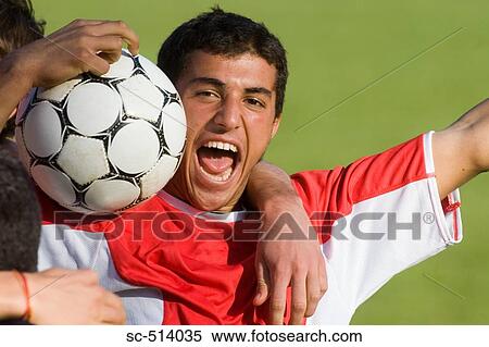 Stock Photography - Boy shouting with Soccer ball. Fotosearch