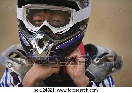 Stock Image - Boy Taking off Helmet. Fotosearch