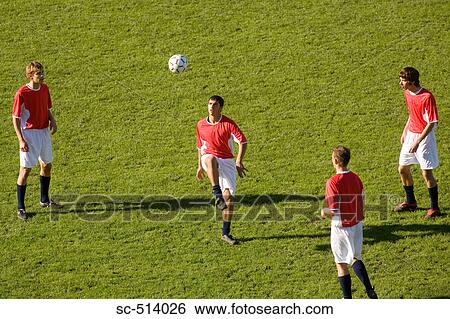 Stock Photograph - Boys juggling Soccer ball. Fotosearch