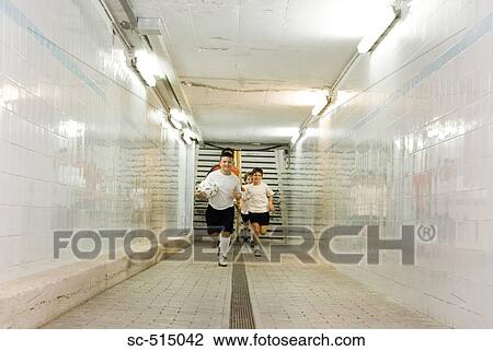 Boys running though a tunnel View Large Photo Image Stock Image - Boys running though a tunnel. Fotosearch