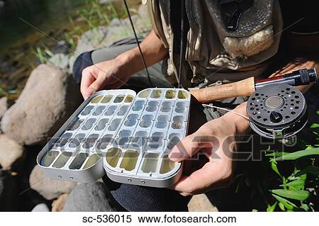 Stock Photography - Close-up of fly fishing box and spool. Fotosearch