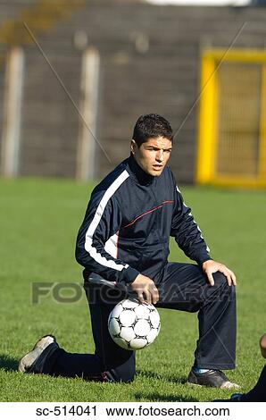Stock Image - Coach kneeling. Fotosearch