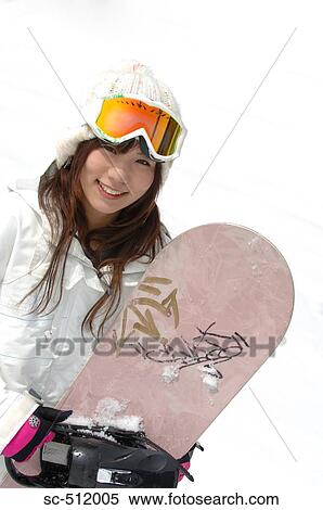 Stock Photography - Cute Asian girl with snowboard. Fotosearch