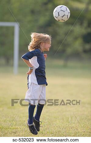 Stock Image - Footballer heading football. Fotosearch