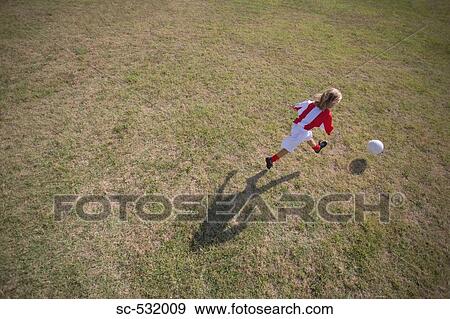 Stock Photo - Footballer kicking soccer ball. Fotosearch