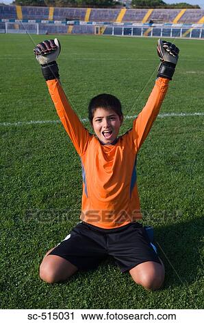 Stock Image - Goal keeper on his knees in celebration. Fotosearch