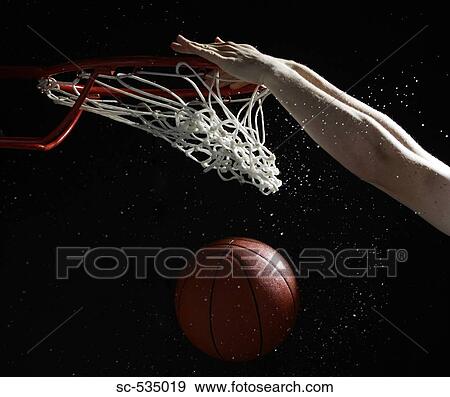Hands of player slam dunking basketball into hoop View Large Photo Image Stock Photo - Hands of player slam dunking basketball into hoop. Fotosearch