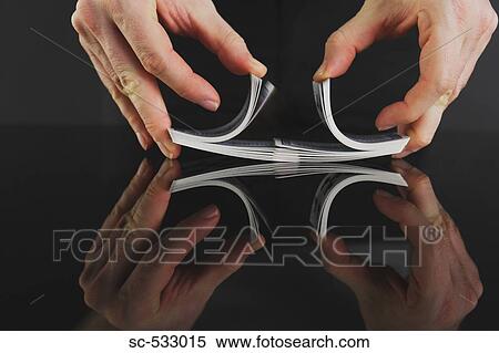 Stock Photography - Hands shuffling deck of playing cards. Fotosearch