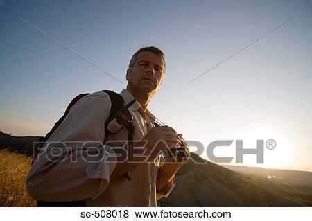 Hiker with binoculars View Large Photo Image Stock Photo - Hiker with binoculars. Fotosearch
