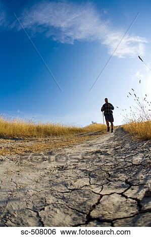 Stock Photograph - Male hiker on track. Fotosearch