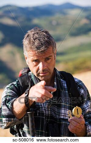 Male hiker with compass View Large Photo Image Stock Photograph - Male hiker with compass. Fotosearch