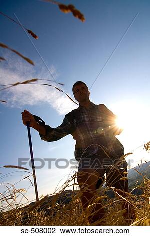 Stock Image - Male hiker with pole. Fotosearch