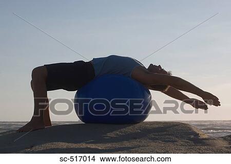 Man Excersizing on a Ball View Large Photo Image Picture - Man Excersizing on a Ball. Fotosearch
