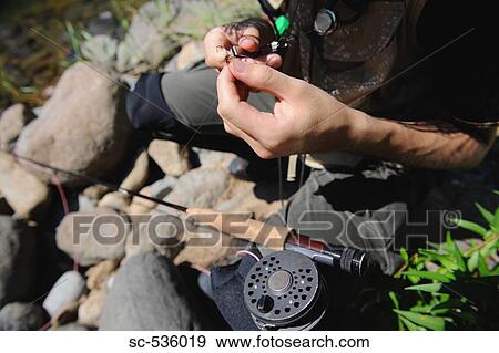 Man holding Dry Fly View Large Photo Image Stock Photo - Man holding Dry Fly. Fotosearch