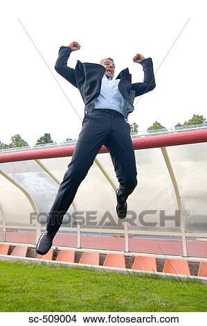 Picture - Man in suit jumping. Fotosearch
