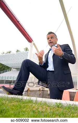 Stock Image - Man in suit looking challenging. Fotosearch