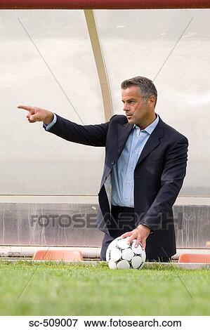 Stock Photo - Man in suit pointing. Fotosearch