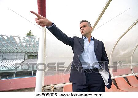 Stock Photography - Man in suit pointing. Fotosearch