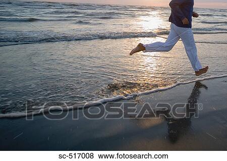 Man Jogging on a Beach View Large Photo Image Stock Photo - Man Jogging on a Beach. Fotosearch