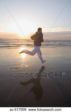 Man Jogging on a Beach View Large Photo Image Stock Photo - Man Jogging on a Beach. Fotosearch