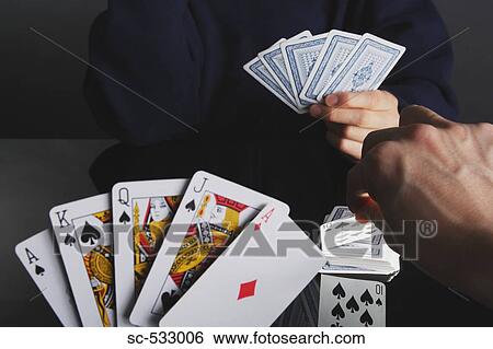 Man showing his cards while playing Poker, View Large Photo Image Stock Photograph - Man showing his cards while playing Poker,. Fotosearch