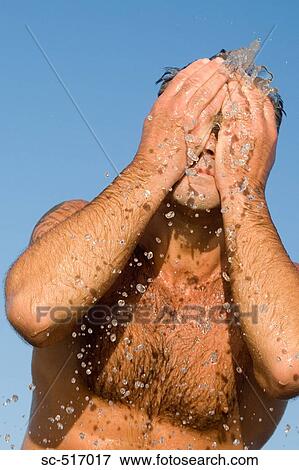 Man Slapping Water On His Face View Large Photo Image Stock Photo - Man Slapping Water On His Face. Fotosearch