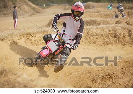 Stock Image - Motocross Rider Turning. Fotosearch