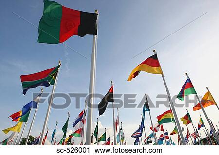 Multinational flags waving against sky View Large Photo Image Stock Image - Multinational flags waving against sky. Fotosearch