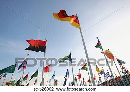 Multinational flags waving against sky View Large Photo Image Stock Image - Multinational flags waving against sky. Fotosearch