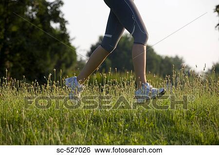 Stock Photograph - Person jogging in countryside. Fotosearch