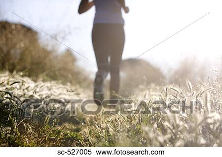Stock Photography - Person jogging in countryside. Fotosearch