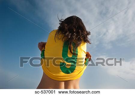 Stock Image - Player stripping soccer uniform. Fotosearch