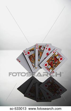 Stock Image - Poker, hand showing reflection of royal flush in diamond. Fotosearch