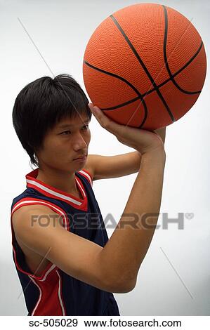 Stock Photo - Portrait of an Asian Basketball Player. Fotosearch