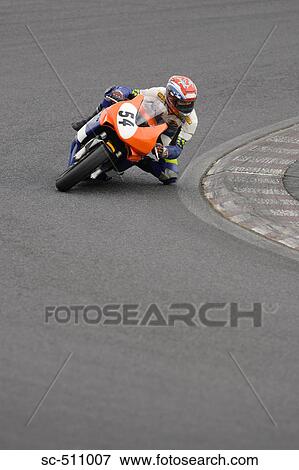 Stock Photo - Racing motor bike cornering at speed. Fotosearch