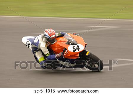 Stock Photography - Racing motor bike cornering at speed. Fotosearch