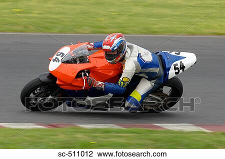 Stock Image - Racing motor bike cornering. Fotosearch
