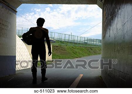 Stock Image - Rear view of motor racing biker in tunnel. Fotosearch