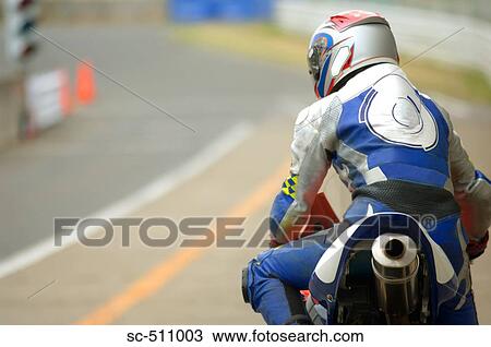 Rear view of racing motor biker on motorcycle View Large Photo Image Stock Image - Rear view of racing motor biker on motorcycle. Fotosearch