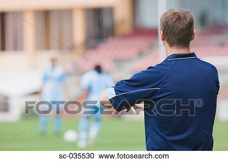Rear view of soccer coach View Large Photo Image Stock Image - Rear view of soccer coach. Fotosearch