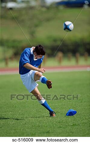 Stock Photo - Rugby Player Kicking A Rugby Ball From A Set Peice. Fotosearch
